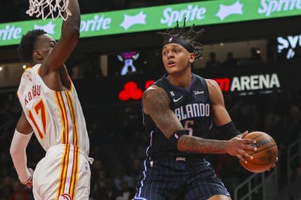 Oct 21, 2022; Atlanta, Georgia, USA; Orlando Magic forward Paolo Banchero (5) passes around Atlanta Hawks forward Onyeka Okongwu (17) in the first quarter at State Farm Arena. Mandatory Credit: Brett Davis-USA TODAY Sports