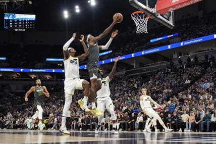 Oct 21, 2022; Minneapolis, Minnesota, USA; Minnesota Timberwolves forward Jaden McDaniels (3) shoots the ball while being fouled by Utah Jazz forward Jarred Vanderbilt (8) during the first quarter at Target Center. Mandatory Credit: Nick Wosika-USA TODAY Sports