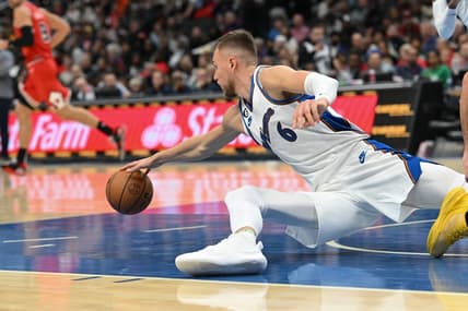 Oct 21, 2022; Washington, District of Columbia, USA;  Washington Wizards center Kristaps Porzingis (6) dives for a loose ball during the second half against the Chicago Bulls  at Capital One Arena. Mandatory Credit: Tommy Gilligan-USA TODAY Sports