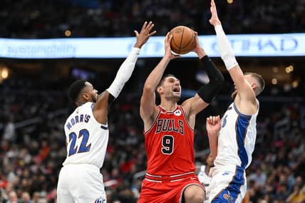 Oct 21, 2022; Washington, District of Columbia, USA;  Chicago Bulls center Nikola Vucevic (9) shoots in-between Washington Wizards guard Monte Morris (22) and center Kristaps Porzingis (6) during the second half at Capital One Arena. Mandatory Credit: Tommy Gilligan-USA TODAY Sports