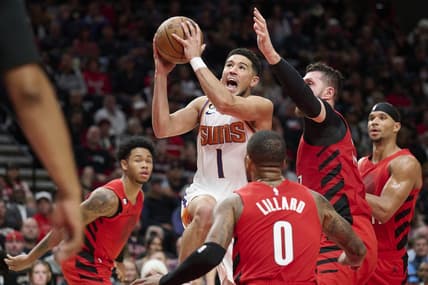 Oct 21, 2022; Portland, Oregon, USA; Phoenix Suns guard Devin Booker (1) drives to the basket during the first half against Portland Trail Blazers center Jusuf Nurkic (27) at Moda Center. Mandatory Credit: Troy Wayrynen-USA TODAY Sports