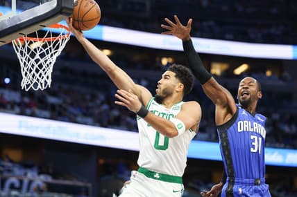 Oct 22, 2022; Orlando, Florida, USA;  Boston Celtics forward Jayson Tatum (0) shoots the ball over Orlando Magic guard Terrence Ross (31) in the first quarter at Amway Center. Mandatory Credit: Nathan Ray Seebeck-USA TODAY Sports