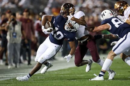 Oct 22, 2022; University Park, Pennsylvania, USA; Penn State Nittany Lions running back Nicholas Singleton (10) runs with the ball as Minnesota Golden Gophers defensive back Beanie Bishop (7) attempts a tackle during the second quarter at Beaver Stadium. Mandatory Credit: Matthew OHaren-USA TODAY Sports