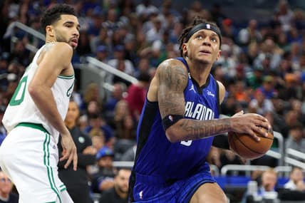 Oct 22, 2022; Orlando, Florida, USA;  Orlando Magic forward Paolo Banchero (5) drives to the hoop past Boston Celtics forward Jayson Tatum (0) in the fourth quarter at Amway Center. Mandatory Credit: Nathan Ray Seebeck-USA TODAY Sports