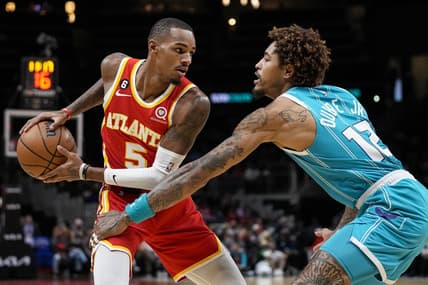 Oct 23, 2022; Atlanta, Georgia, USA; Atlanta Hawks guard Dejounte Murray (5) controls the ball against Charlotte Hornets guard Kelly Oubre Jr. (12) during the first half at State Farm Arena. Mandatory Credit: Dale Zanine-USA TODAY Sports