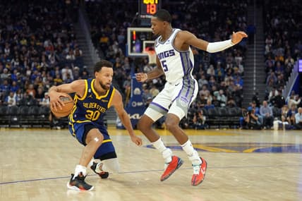 Oct 23, 2022; San Francisco, California, USA; Golden State Warriors guard Stephen Curry (30) dribbles against Sacramento Kings guard De'Aaron Fox (5) during the third quarter at Chase Center. Mandatory Credit: Darren Yamashita-USA TODAY Sports