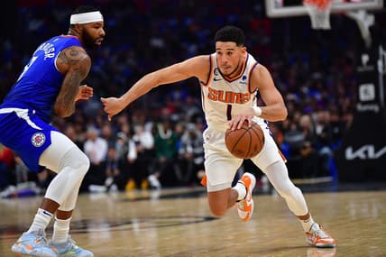Oct 23, 2022; Los Angeles, California, USA; Phoenix Suns guard Devin Booker (1) moves the ball against Los Angeles Clippers forward Marcus Morris Sr. (8) during the first half at Crypto.com Arena. Mandatory Credit: Gary A. Vasquez-USA TODAY Sports