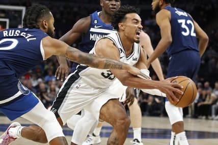 Oct 26, 2022; Minneapolis, Minnesota, USA; Minnesota Timberwolves guard D'Angelo Russell (0) fouls San Antonio Spurs guard Tre Jones (33) in the first quarter at Target Center. Mandatory Credit: Bruce Kluckhohn-USA TODAY Sports