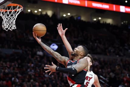Oct 26, 2022; Portland, Oregon, USA; Portland Trail Blazers point guard Damian Lillard (0) drives to the basket past  Miami Heat forward Nikola Jovic (5) during the first half at Moda Center. Mandatory Credit: Soobum Im-USA TODAY Sports