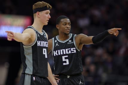 Oct 27, 2022; Sacramento, California, USA; Sacramento Kings guard De'Aaron Fox (5) and guard Kevin Huerter (9) talk at half court during the second quarter against the Memphis Grizzlies at Golden 1 Center. Mandatory Credit: Sergio Estrada-USA TODAY Sports
