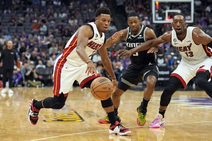Oct 29, 2022; Sacramento, California, USA; Miami Heat guard Kyle Lowry (7) dribbles against Sacramento Kings guard De'Aaron Fox (5) as center Bam Adebayo (13) sets a screen during the second quarter at Golden 1 Center. Mandatory Credit: Darren Yamashita-USA TODAY Sports