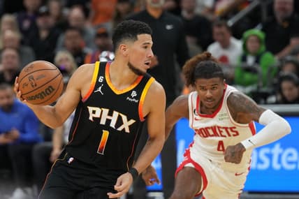 Oct 30, 2022; Phoenix, Arizona, USA; Phoenix Suns guard Devin Booker (1) dribbles against Houston Rockets guard Jalen Green (4) during the second half at Footprint Center. Mandatory Credit: Joe Camporeale-USA TODAY Sports