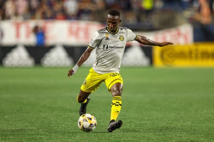 Sep 18, 2021; Foxborough, Massachusetts, USA; Columbus Crew midfielder Derrick Etienne Jr (22) passes the ball for an assist during the second half against the New England Revolution at Gillette Stadium. Mandatory Credit: Paul Rutherford-USA TODAY Sports