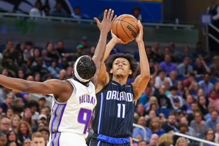 Mar 26, 2022; Orlando, Florida, USA; Orlando Magic guard Jeff Dowtin (11) shoots the ball against Sacramento Kings forward Justin Holiday (9) during the second half at Amway Center. Mandatory Credit: Mike Watters-USA TODAY Sports