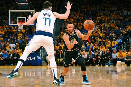 May 26, 2022; San Francisco, California, USA; Golden State Warriors guard Stephen Curry (30) passes the ball against Dallas Mavericks guard Luka Doncic (77) during the second half of game five of the 2022 western conference finals at Chase Center. Mandatory Credit: Kelley L Cox-USA TODAY Sports