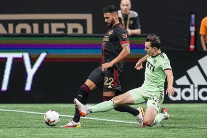 Jul 9, 2022; Atlanta, Georgia, USA; Austin FC midfielder Jared Stroud (20) kicks the ball away from Atlanta United defender Juan Jose Purata during the second half at Mercedes-Benz Stadium. Mandatory Credit: Dale Zanine-USA TODAY Sports