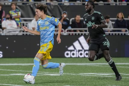 Oct 1, 2022; Charlotte, North Carolina, USA; Philadelphia Union midfielder Paxten Aaronson (30) dribbles the ball while chased by Charlotte FC midfielder Derrick Jones (20) during the second half at Bank of America Stadium. Mandatory Credit: Jim Dedmon-USA TODAY Sports