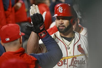Oct 8, 2022; St. Louis, Missouri, USA; St. Louis Cardinals designated hitter Albert Pujols (5) is congratulated in the dugout following his single in the eighth inning against the Philadelphia Phillies during game two of the Wild Card series for the 2022 MLB Playoffs at Busch Stadium. Mandatory Credit: Jeff Curry-USA TODAY Sports