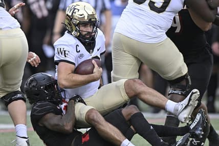 Oct 29, 2022; Louisville, Kentucky, USA;  Louisville Cardinals defensive back Kei'Trel Clark (13) sacks Wake Forest Demon Deacons quarterback Sam Hartman (10)  during the first half at Cardinal Stadium. Louisville defeated Wake Forest 48-21. Mandatory Credit: Jamie Rhodes-USA TODAY Sports