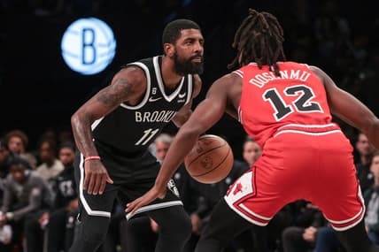 Nov 1, 2022; Brooklyn, New York, USA; Brooklyn Nets guard Kyrie Irving (11) dribbles as Chicago Bulls guard Ayo Dosunmu (12) defends during the first quarter at Barclays Center. Mandatory Credit: Vincent Carchietta-USA TODAY Sports