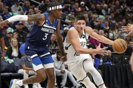 Nov 4, 2022; Minneapolis, Minnesota, USA; Milwaukee Bucks forward Grayson Allen (12) brings the ball around Minnesota Timberwolves forward Jaden McDaniels (3) in the first quarter at Target Center. Mandatory Credit: Bruce Kluckhohn-USA TODAY Sports