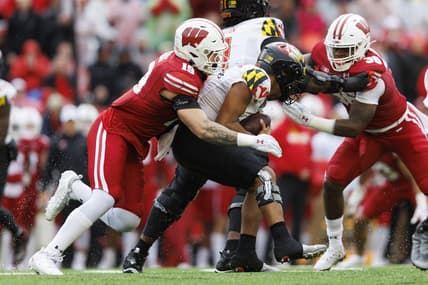 Nov 5, 2022; Madison, Wisconsin, USA;  Wisconsin Badgers linebacker Nick Herbig (19) tackles Maryland Terrapins quarterback Taulia Tagovailoa (3) during the second quarter at Camp Randall Stadium. Mandatory Credit: Jeff Hanisch-USA TODAY Sports