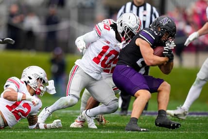 Nov 5, 2022; Evanston, Illinois, USA; Ohio State Buckeyes cornerback Denzel Burke (10) tackles Northwestern Wildcats running back Evan Hull (26) during the first half of the NCAA football game at Ryan Field. Mandatory Credit: Adam Cairns-The Columbus Dispatch

Ncaa Football Ohio State Buckeyes At Northwestern Wildcats