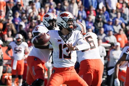 Nov 5, 2022; Lawrence, Kansas, USA; Oklahoma State Cowboys quarterback Garret Rangel (13) throws a pass against the Kansas Jayhawks during the first half of the game at David Booth Kansas Memorial Stadium. Mandatory Credit: Denny Medley-USA TODAY Sports