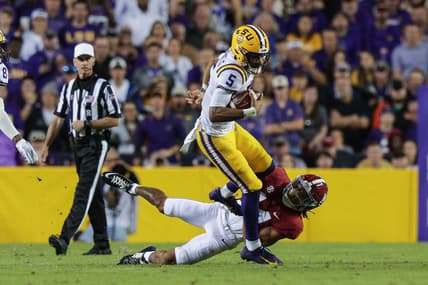 Nov 5, 2022; Baton Rouge, Louisiana, USA; Alabama Crimson Tide defensive back Brian Branch (14) tackles LSU Tigers quarterback Jayden Daniels (5) during the first half at Tiger Stadium. Mandatory Credit: Stephen Lew-USA TODAY Sports