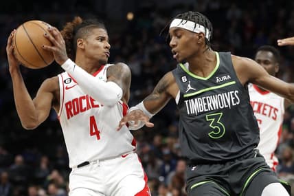 Nov 5, 2022; Minneapolis, Minnesota, USA; Houston Rockets guard Jalen Green (4) controls the ball against Minnesota Timberwolves forward Jaden McDaniels (3) in the first quarter at Target Center. Mandatory Credit: Bruce Kluckhohn-USA TODAY Sports