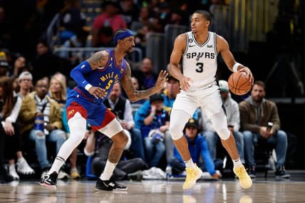 Nov 5, 2022; Denver, Colorado, USA; San Antonio Spurs forward Keldon Johnson (3) controls the ball as Denver Nuggets guard Kentavious Caldwell-Pope (5) guards in the second quarter at Ball Arena. Mandatory Credit: Isaiah J. Downing-USA TODAY Sports
