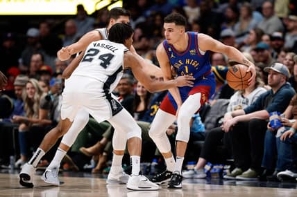 Nov 5, 2022; Denver, Colorado, USA; Denver Nuggets forward Michael Porter Jr. (1) controls the ball under pressure from San Antonio Spurs guard Devin Vassell (24) and forward Doug McDermott (17) in the fourth quarter at Ball Arena. Mandatory Credit: Isaiah J. Downing-USA TODAY Sports