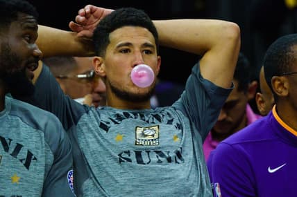 Nov 5, 2022; Phoenix, Arizona, USA; Phoenix Suns guard Devin Booker (1) blows a bubble between plays during the second half against the Portland Trail Blazers at Footprint Center. Mandatory Credit: Allan Henry-USA TODAY Sports
