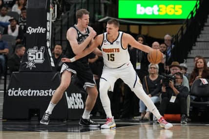 Nov 7, 2022; San Antonio, Texas, USA;  Denver Nuggets center Nikola Jokic (15) backs in against San Antonio Spurs center Jakob Poeltl (25) in the first half at the AT&T Center. Mandatory Credit: Daniel Dunn-USA TODAY Sports