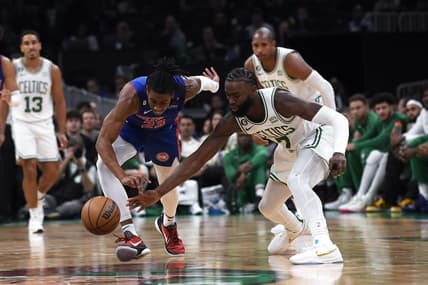 Nov 9, 2022; Boston, Massachusetts, USA; Detroit Pistons guard Jaden Ivey (23) and Boston Celtics guard Jaylen Brown (7) battle for a loose ball during the first half at TD Garden. Mandatory Credit: Bob DeChiara-USA TODAY Sports