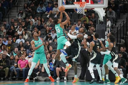 Nov 11, 2022; San Antonio, Texas, USA;  San Antonio Spurs guard Devin Vassell (24) shoots over Milwaukee Bucks forward Serge Ibaka (25) in the first half at the AT&T Center. Mandatory Credit: Daniel Dunn-USA TODAY Sports