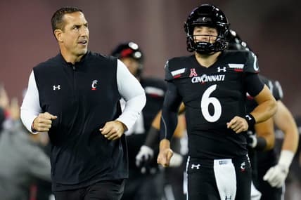 Cincinnati Bearcats head coach Luke Fickell and quarterback Ben Bryant (6) take the field for the first quarter of the NCAA American Athletic Conference game between the Cincinnati Bearcats and the East Carolina Pirates at Nippert Stadium in Cincinnati on Friday, Nov. 11, 2022.

East Carolina Pirates At Cincinnati Bearcats Football