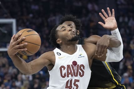November 11, 2022; San Francisco, California, USA; Cleveland Cavaliers guard Donovan Mitchell (45) is fouled by Golden State Warriors forward Andrew Wiggins (22) during the second quarter at Chase Center. Mandatory Credit: Kyle Terada-USA TODAY Sports