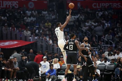 Nov 12, 2022; Los Angeles, California, USA;  Brooklyn Nets forward Kevin Durant (7) shoots a ball against LA Clippers guard Paul George (13) and forward Marcus Morris Sr. (8) during the first quarter at Crypto.com Arena. Mandatory Credit: Kiyoshi Mio-USA TODAY Sports
