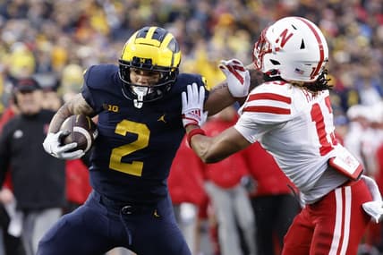 Nov 12, 2022; Ann Arbor, Michigan, USA;  Michigan Wolverines running back Blake Corum (2) stiff arms Nebraska Cornhuskers defensive back Malcolm Hartzog (13) in the first half at Michigan Stadium. Mandatory Credit: Rick Osentoski-USA TODAY Sports