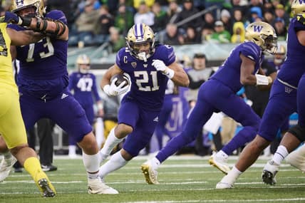 Nov 12, 2022; Eugene, Oregon, USA; Washington Huskies running back Wayne Taulapapa (21) carries the ball for a touchdown during the first half against the Oregon Ducks at Autzen Stadium. Mandatory Credit: Troy Wayrynen-USA TODAY Sports