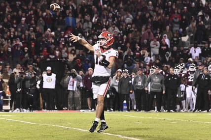 Nov 12, 2022; Starkville, Mississippi, USA; Georgia Bulldogs quarterback Stetson Bennett (13) throws a pass against the Mississippi State Bulldogs that would result in a touchdown during the first quarter at Davis Wade Stadium at Scott Field. Mandatory Credit: Matt Bush-USA TODAY Sports