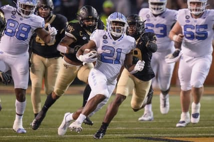 Nov 12, 2022; Winston-Salem, North Carolina, USA;  North Carolina Tar Heels running back Elijah Green (21) outruns the Wake Forest Demon Deacons defense during the first half at Truist Field. Mandatory Credit: Jim Dedmon-USA TODAY Sports