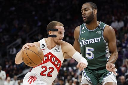 Nov 14, 2022; Detroit, Michigan, USA;  Toronto Raptors guard Malachi Flynn (22) dribbles defended by Detroit Pistons guard Alec Burks (5) in the first half at Little Caesars Arena. Mandatory Credit: Rick Osentoski-USA TODAY Sports
