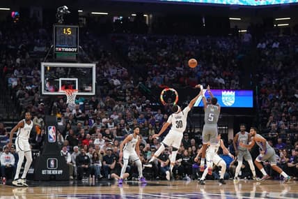 Nov 15, 2022; Sacramento, California, USA; Sacramento Kings guard De'Aaron Fox (5) makes a shot over Brooklyn Nets guard Seth Curry (30) at the end of the first quarter at the Golden 1 Center. Mandatory Credit: Cary Edmondson-USA TODAY Sports