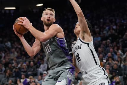 Nov 15, 2022; Sacramento, California, USA; Sacramento Kings forward Domantas Sabonis (10) holds onto the ball next to Brooklyn Nets guard Yuta Watanabe (18) in the third quarter at the Golden 1 Center. Mandatory Credit: Cary Edmondson-USA TODAY Sports