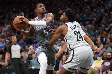 Nov 15, 2022; Sacramento, California, USA; Sacramento Kings guard De'Aaron Fox (5) drives to the hoop next to Brooklyn Nets guard Cam Thomas (24) in the third quarter at the Golden 1 Center. Mandatory Credit: Cary Edmondson-USA TODAY Sports