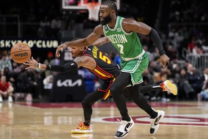 Nov 16, 2022; Atlanta, Georgia, USA; Atlanta Hawks guard Dejounte Murray (5) deflects the ball away from Boston Celtics guard Jaylen Brown (7) during the first half at State Farm Arena. Mandatory Credit: Dale Zanine-USA TODAY Sports