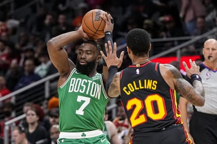 Nov 16, 2022; Atlanta, Georgia, USA; Boston Celtics guard Jaylen Brown (7) is defended by Atlanta Hawks forward John Collins (20) during the first half at State Farm Arena. Mandatory Credit: Dale Zanine-USA TODAY Sports