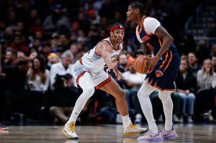 Nov 16, 2022; Denver, Colorado, USA; New York Knicks forward Cam Reddish (0) controls the ball as Denver Nuggets forward Zeke Nnaji (22) defends in the second quarter at Ball Arena. Mandatory Credit: Isaiah J. Downing-USA TODAY Sports